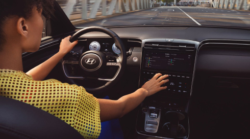 The new i30 Hatchback driving towards a bridge.